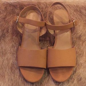 Brown slip on, heeled sandals.